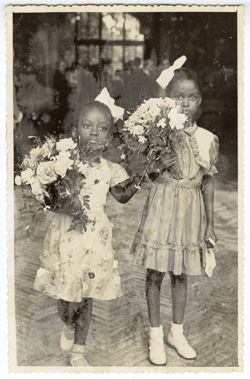 President Tubman's daughter, Coocoo, and friend Banke King hold flowers