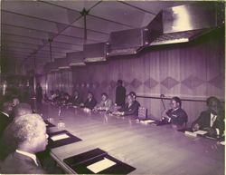 Men in business attire seated at conference table