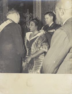 Antoinette Tubman receives a medal and shakes a dignitary's hand