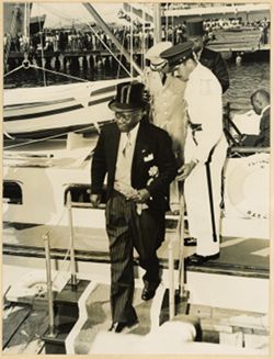 President William V. S. Tubman in formal attire debarks from boat