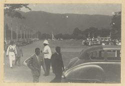 Men and officials walk towards event