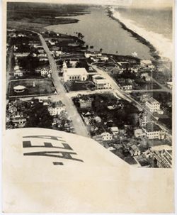 Aerial view of a coastline town shot from an AEA airplane