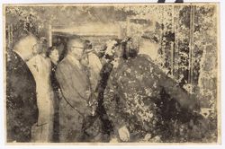 President William V. S. Tubman and others stand together while looking at object