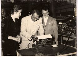 Dignitaries examine a typewriter