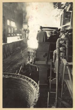 Men stand on walkway watching machinery at Republic Steel Corporation plants