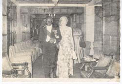 President William V. S. Tubman in formal attire walks with guest in arm