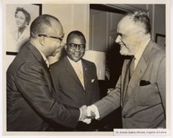 Dr. Arnolds Spekke, Minister, Legation of Latvia shakes hands with another