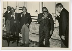 President William V. S. Tubman toasts champagne with fellow officials