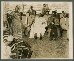 President William V. S. Tubman sits in tradiational attire among guests and officials