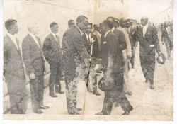 Officials greet each other along a ship dock