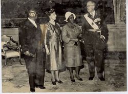 President and Mrs. Tubman stand with woman in formal attire and man in decorated miliary dress