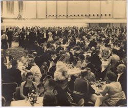 Crowd seated and standing in reception hall