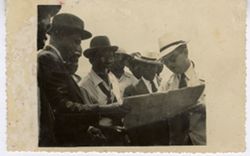 President William V. S. Tubman and officials gather around construction blue prints