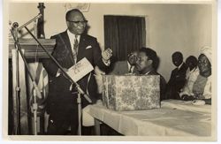 Vice-President William R. Tolbert stands in front of guests at a reception