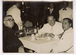 Dignitaries seated at small table