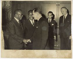 President William V. S. Tubman shakes hands with man in receiving line