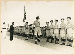 President William V. S. Tubman stands before troops at attention