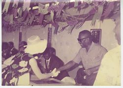 President Tubman shaking hands with woman in white hat