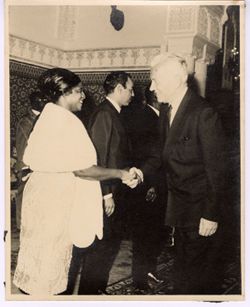 Mrs. Tubman shakes hands with a dignitary