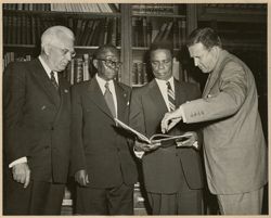 President William V. S. Tubman, Ambassador Clarence Simpson Sr. and others looking at documents in the Ford Motor Company Archives