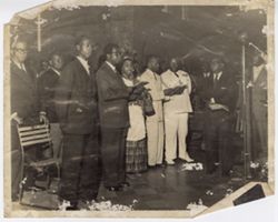 Group sings behind a microphone