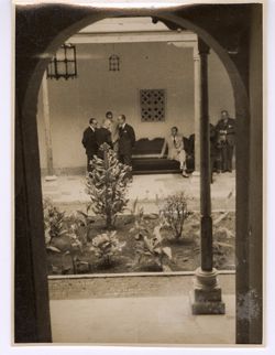 Dignitaries stand in a couryard
