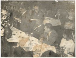 Guests sit at dinner table during reception