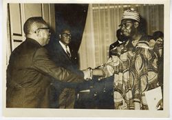President William V. S. Tubman greets man in traditional dress during reception