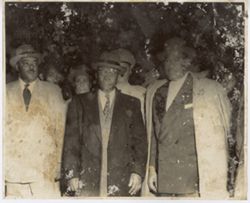 President William V. S. Tubman stands with officials in overcoats and hats