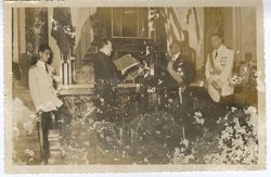 President William V. S. Tubman stand with military officials and dignitaries during ceremony