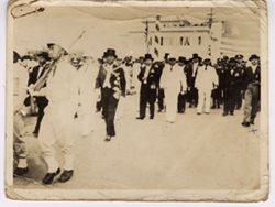 President William V. S. Tubman walks in a parade with soldiers and dignitaries