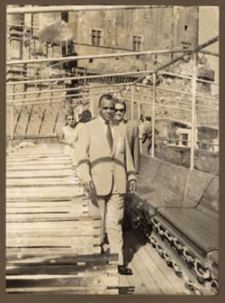 Dignitaries walk along benches on a SS Santa Lucia