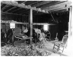 Shed: chair, spinning wheel, two machines with rollers