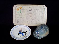Ceramic plate with painting of HC at piano and song titles painted around the edge.
