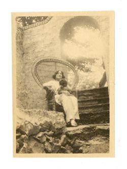 Margaret Howard sitting outdoors, holding a dog