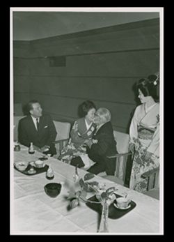 Roy W. Howard kissing woman in Tokio, Japan