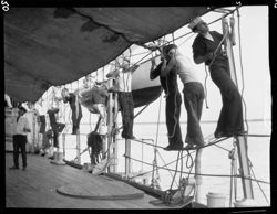 Sailors putting up canvas