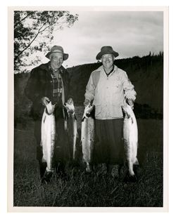 Two men holding fish