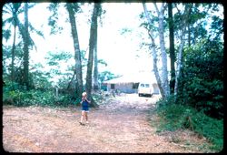 Child walking away from house with van