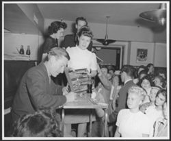 Young woman presenting Stardust Road for Hoagy Carmichael to sign.