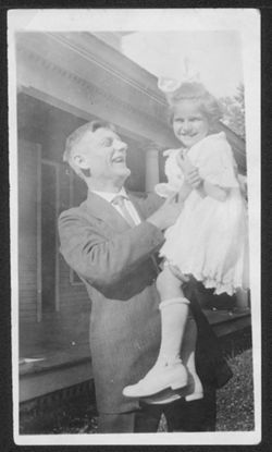 Howard Carmichael holding Harriet Robison.