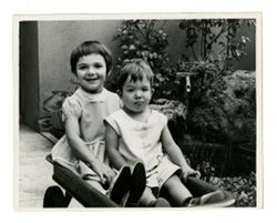 Two children sitting in a wagon