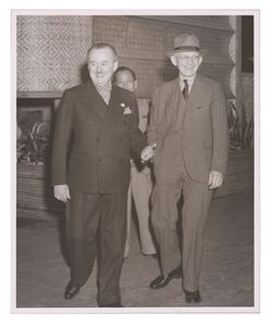 Roy W. Howard walking with man