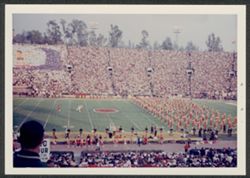 Crowd at Rose Bowl, IU vs. USC, holding cards, band on field.