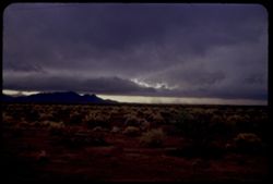 View south from US 70 toward storm clouds moving from west toward Arizona's Whitlock Mtns.