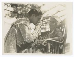 Item 0091. Same setting and subjects as Items 88-90 above. Liceaga kissing woman's hand.