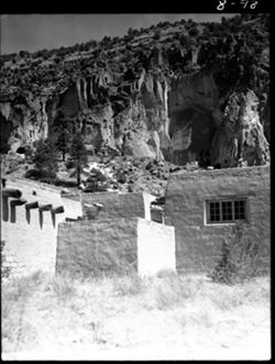 Frijole, ruins in back, cabins in foreground