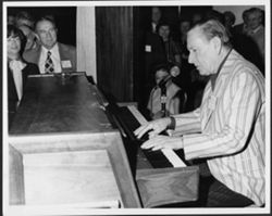 Hoagy Carmichael playing piano at an ASCAP reception.