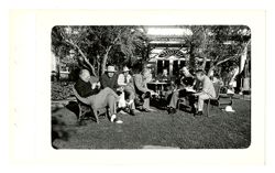 Roy Howard and others eat on lawn