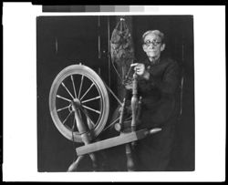 Mrs. Angeline Victor of Indianapolis and her old spinning wheel